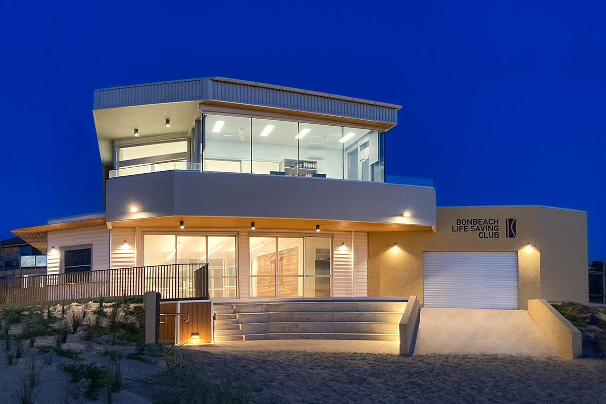 Bonbeach Life Saving Club exterior lighting at dusk in coastal Australia.