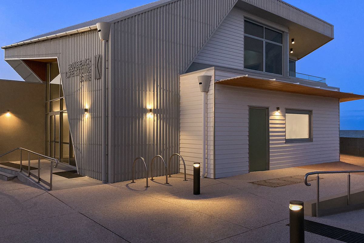 Bonbeach Life Saving Club facade lighting highlighting coastal architecture at night.