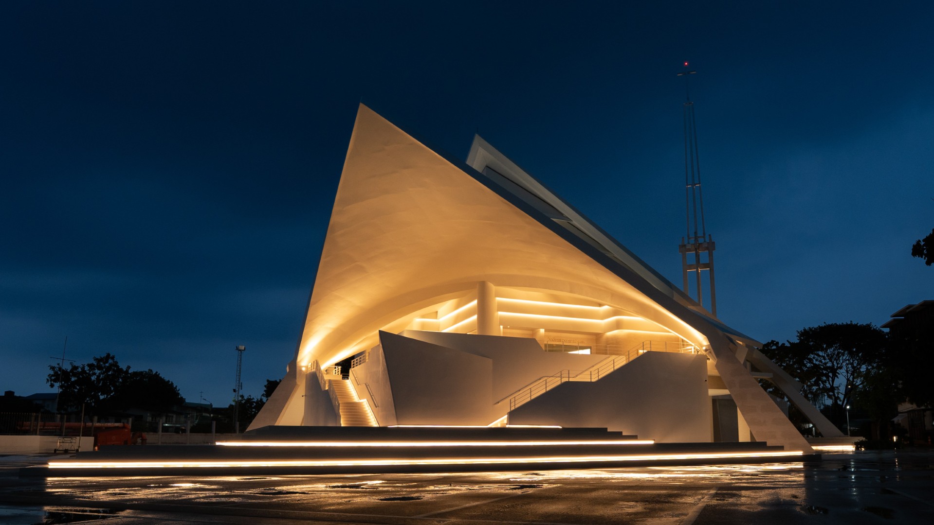 Exterior night view of St. Raphael Catholic Church with warm architectural lighting