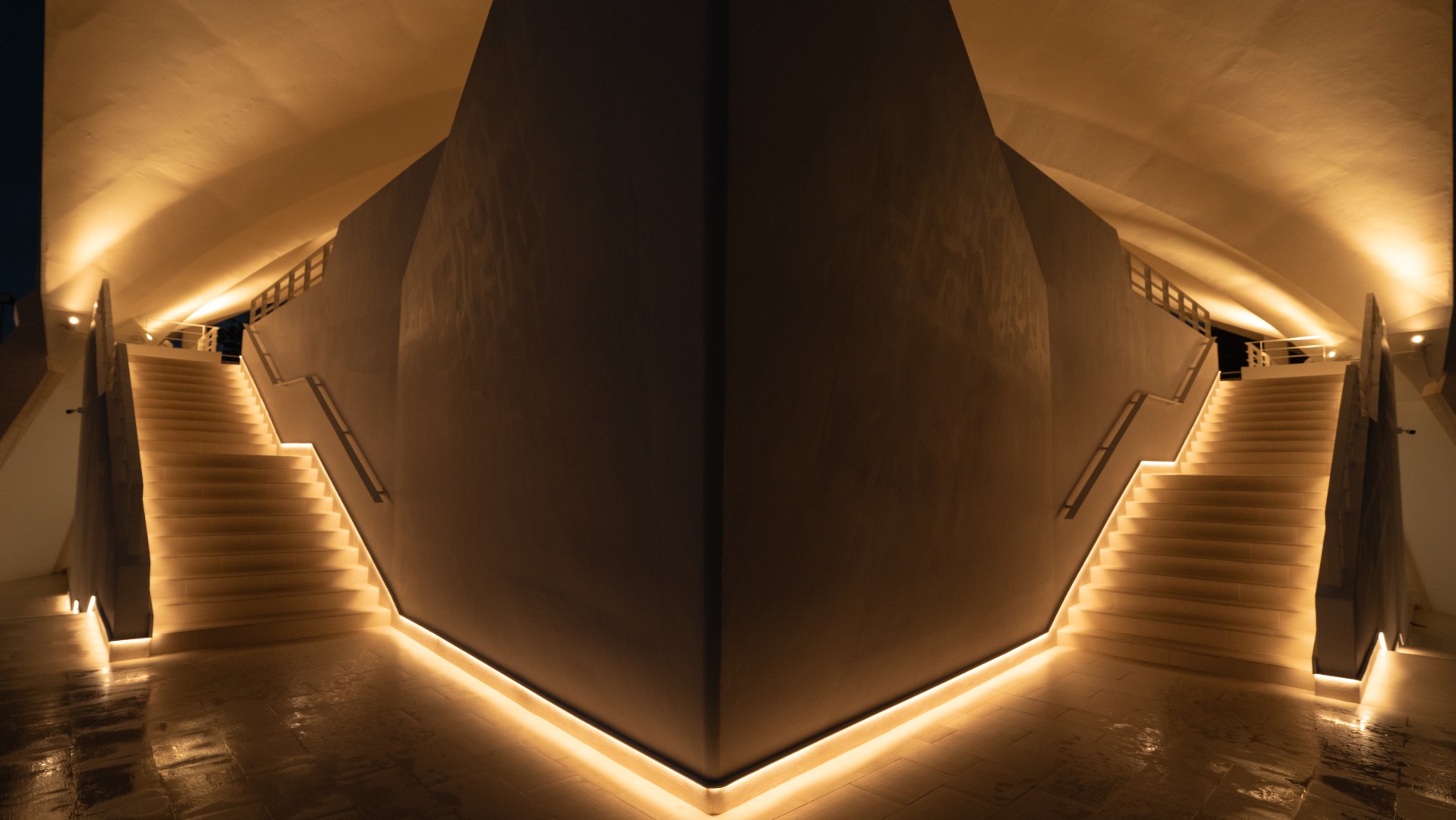 Symmetrical staircase lighting inside St. Raphael Catholic Church at night