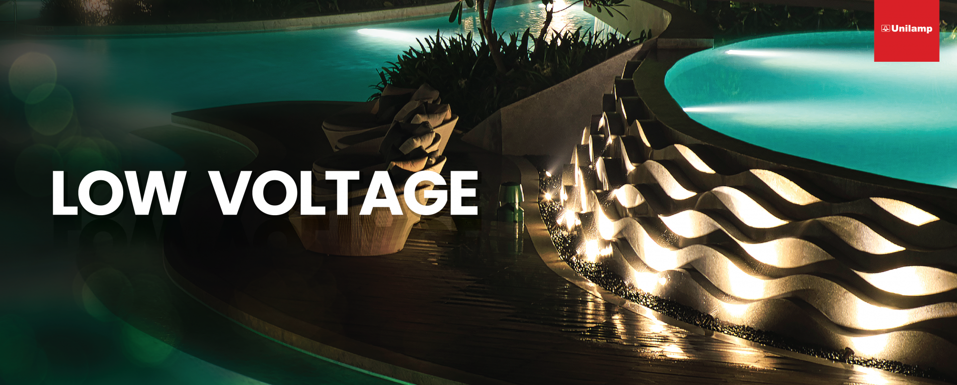 Low voltage outdoor lighting illuminating poolside landscape at night.