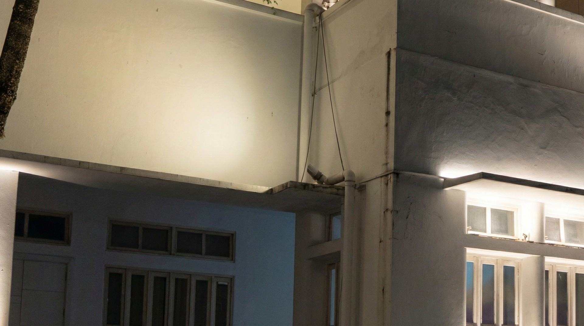 Architectural wall grazing lighting detail on university façade at night