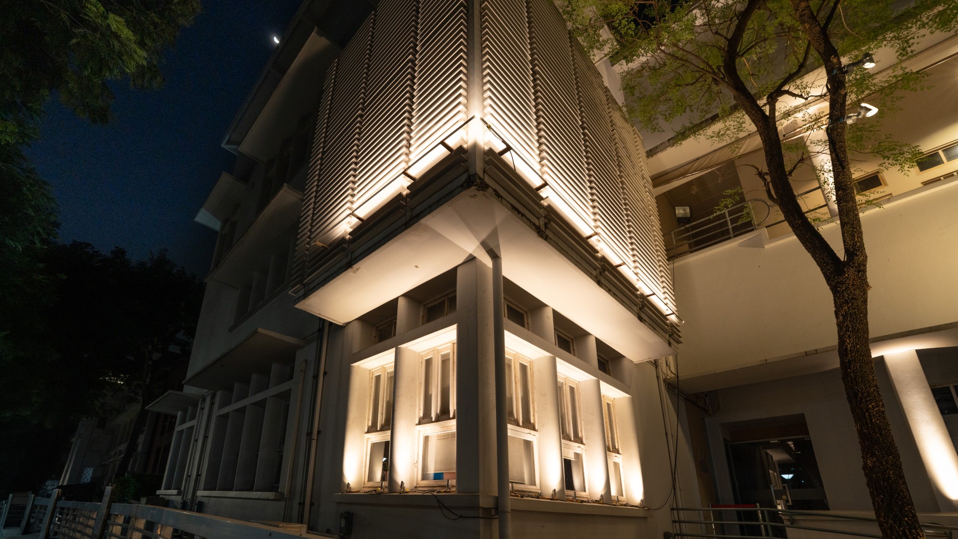 Corner façade uplighting and linear architectural lighting at night