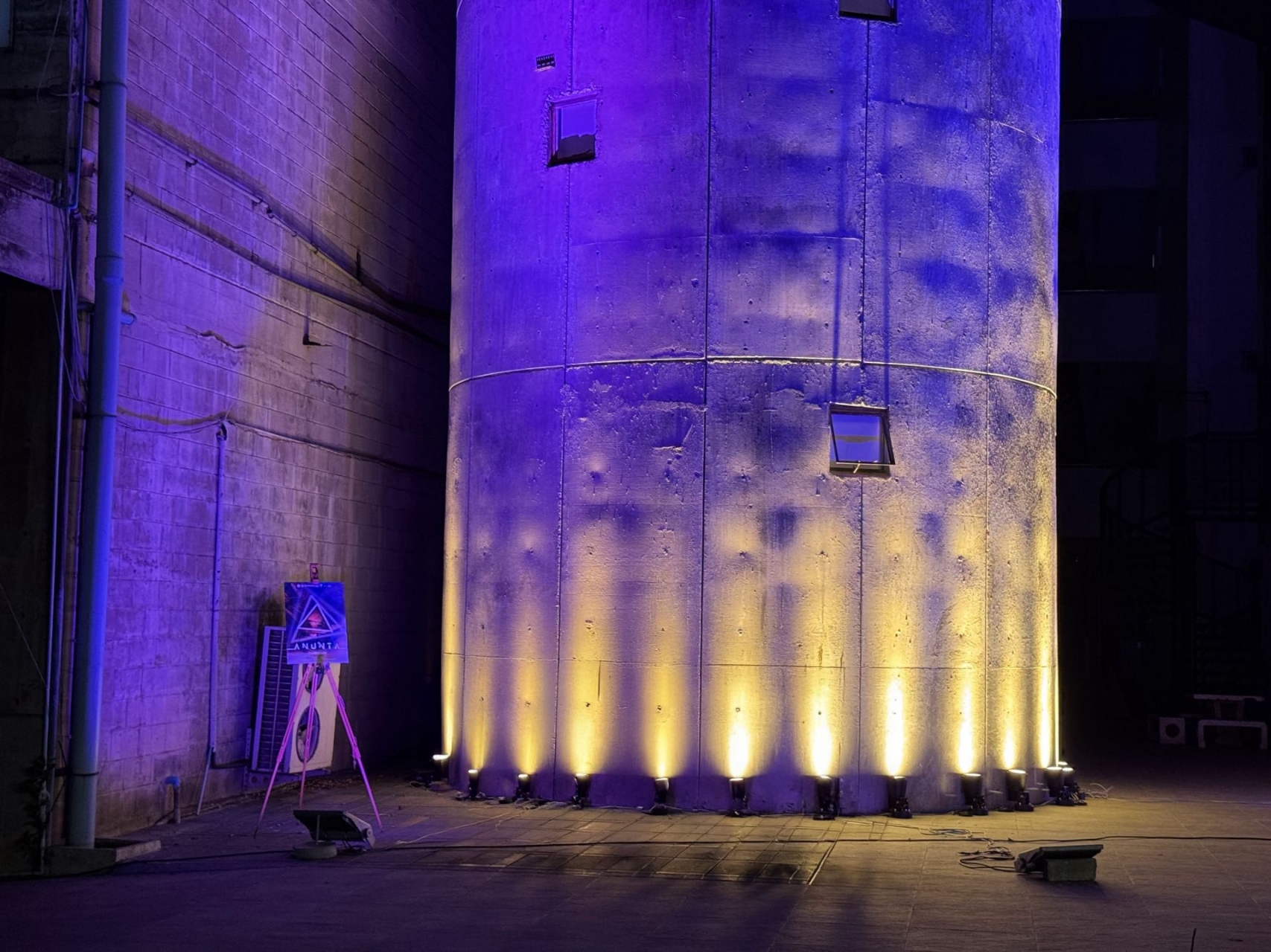 Concrete tower uplighting with warm architectural lighting design