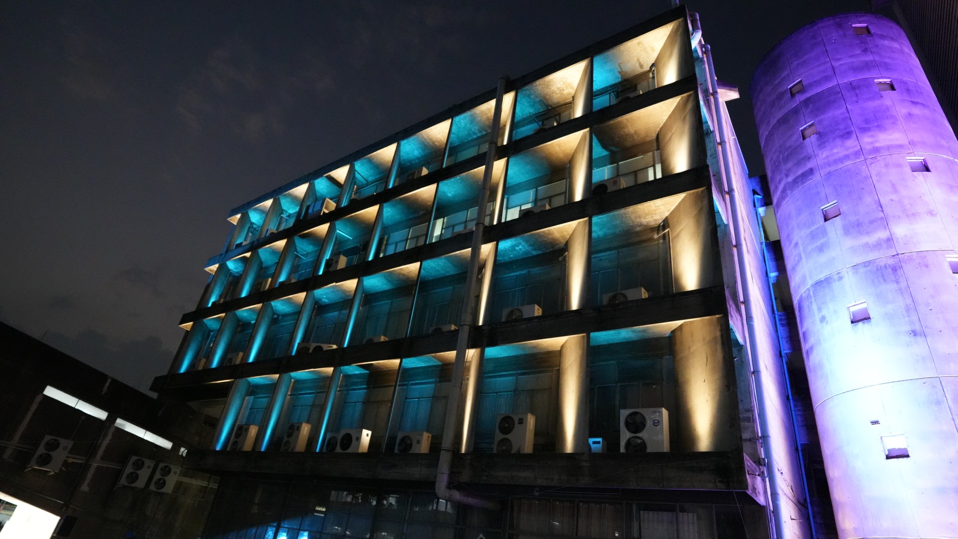 Kasetsart University building facade illuminated with blue and warm lighting