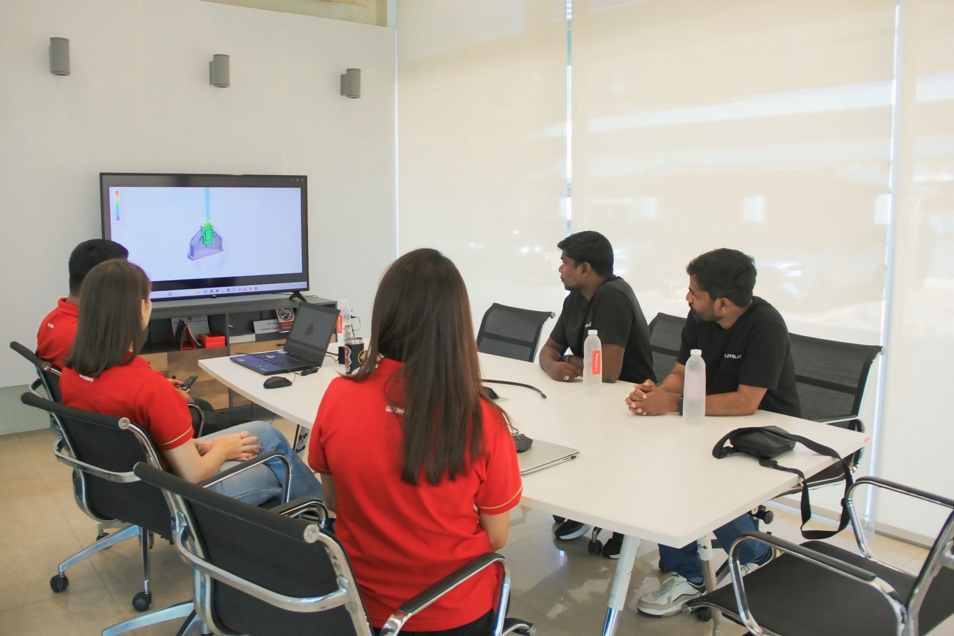 Unilamp and Litelab teams discussing lighting design and future projects in meeting room