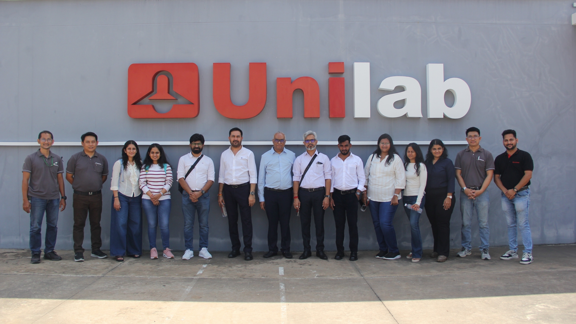 Zion Dzine team and Unilamp staff taking a group photo at the Unilab facility in Thailand.