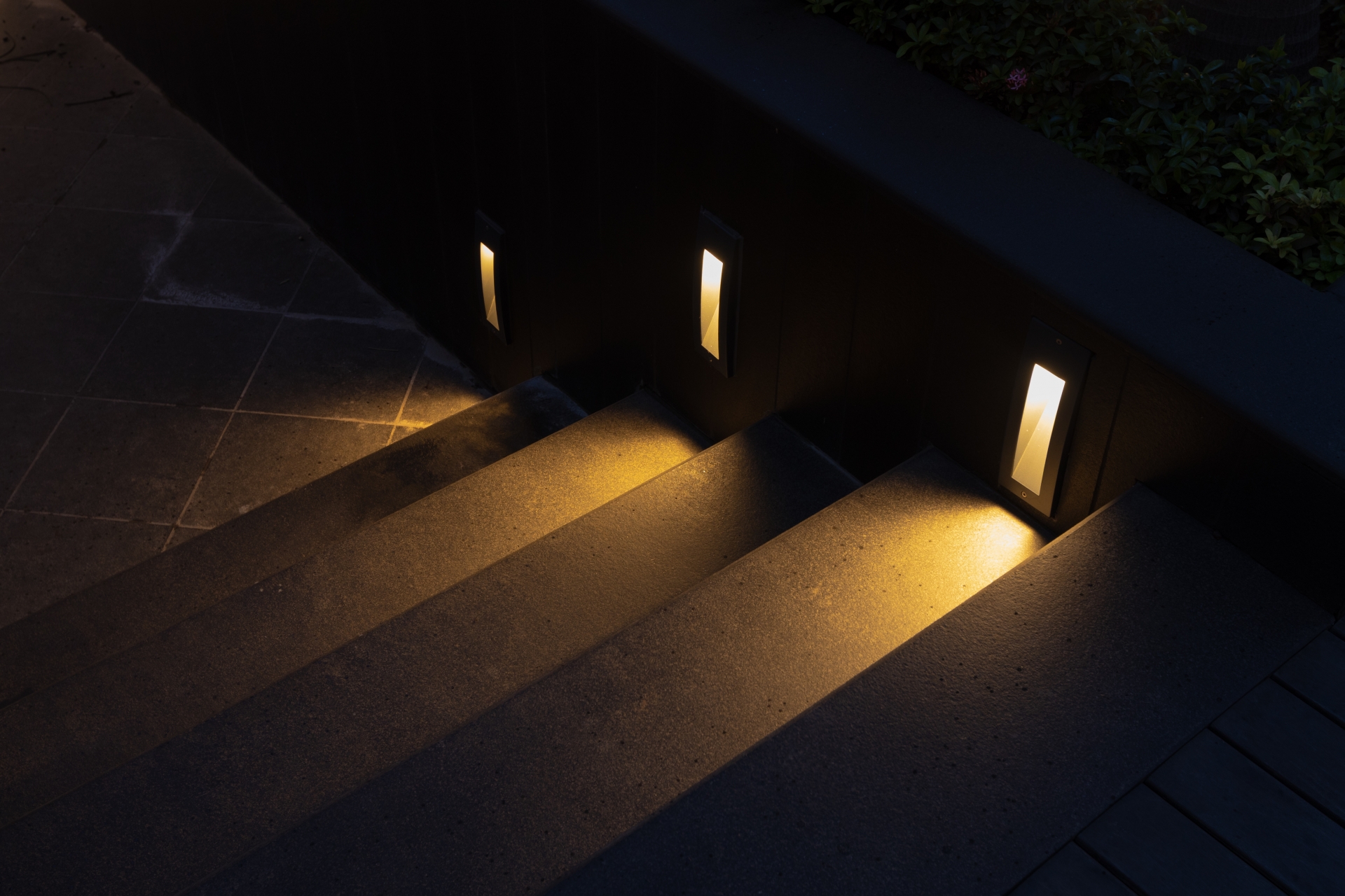 I-BRICK step lights illuminating exterior stairs at Awadh Ayuska for safe nighttime visibility.