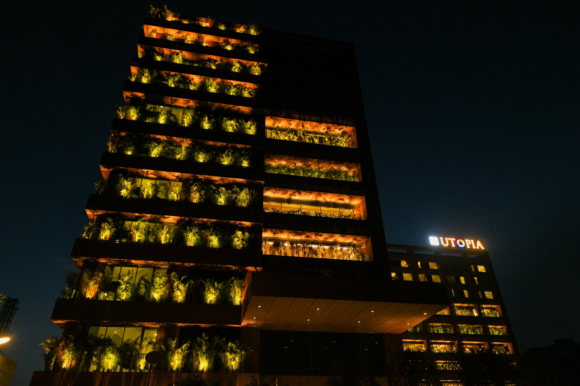 Utopia building with illuminated vertical garden at night