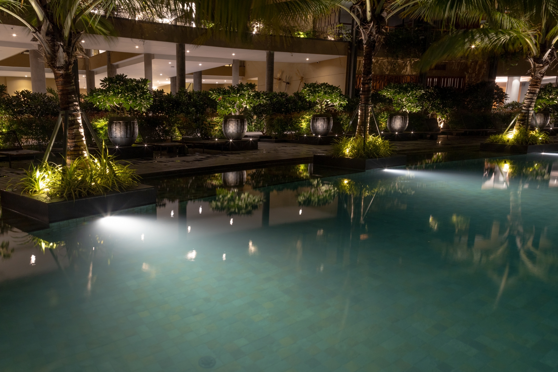 Pool area at Awadh Ayuska illuminated with Unilamp underwater and landscape luminaires for clear nighttime visibility.