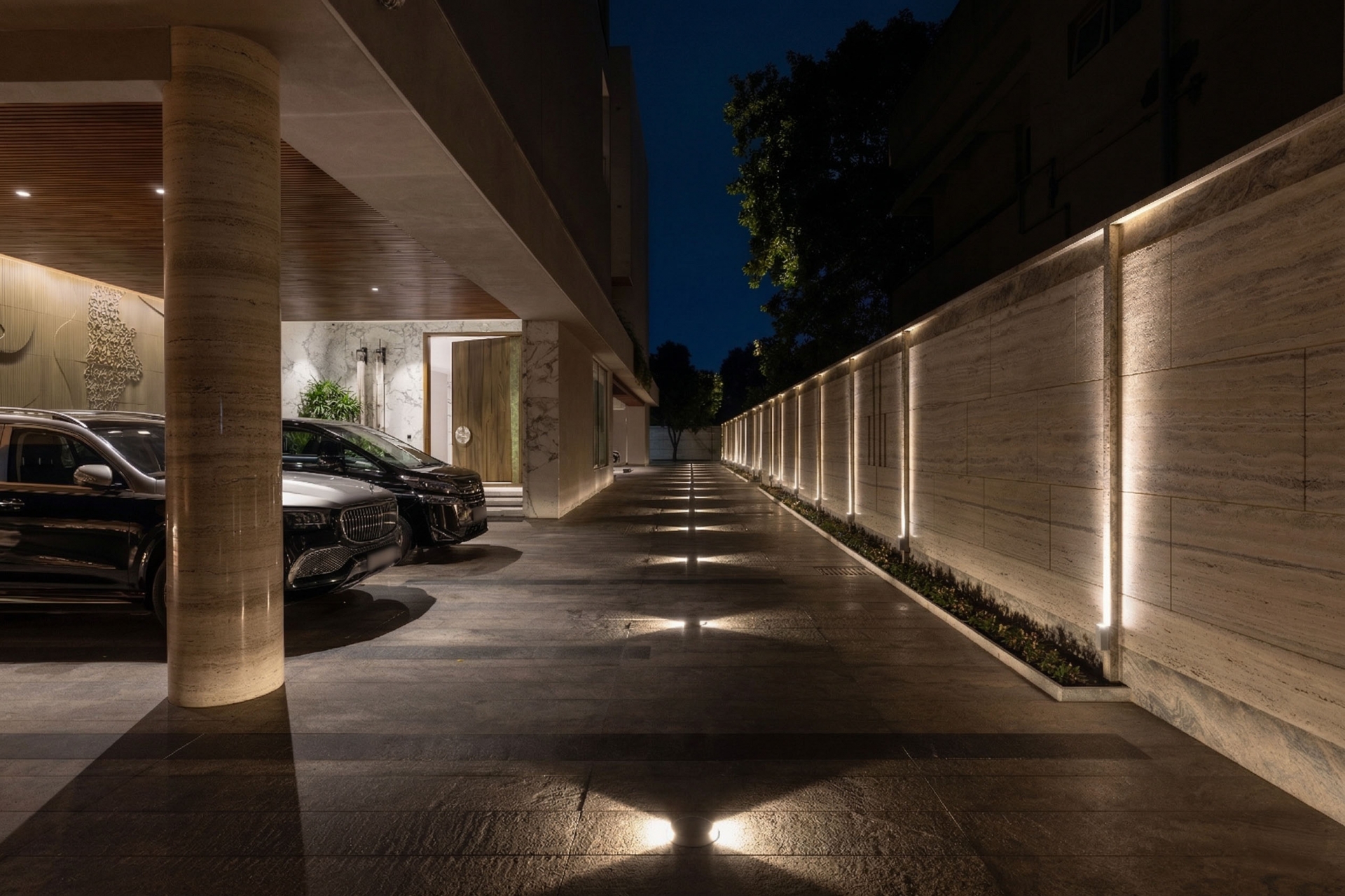 Luxury house driveway with premium outdoor lighting and illuminated wall design