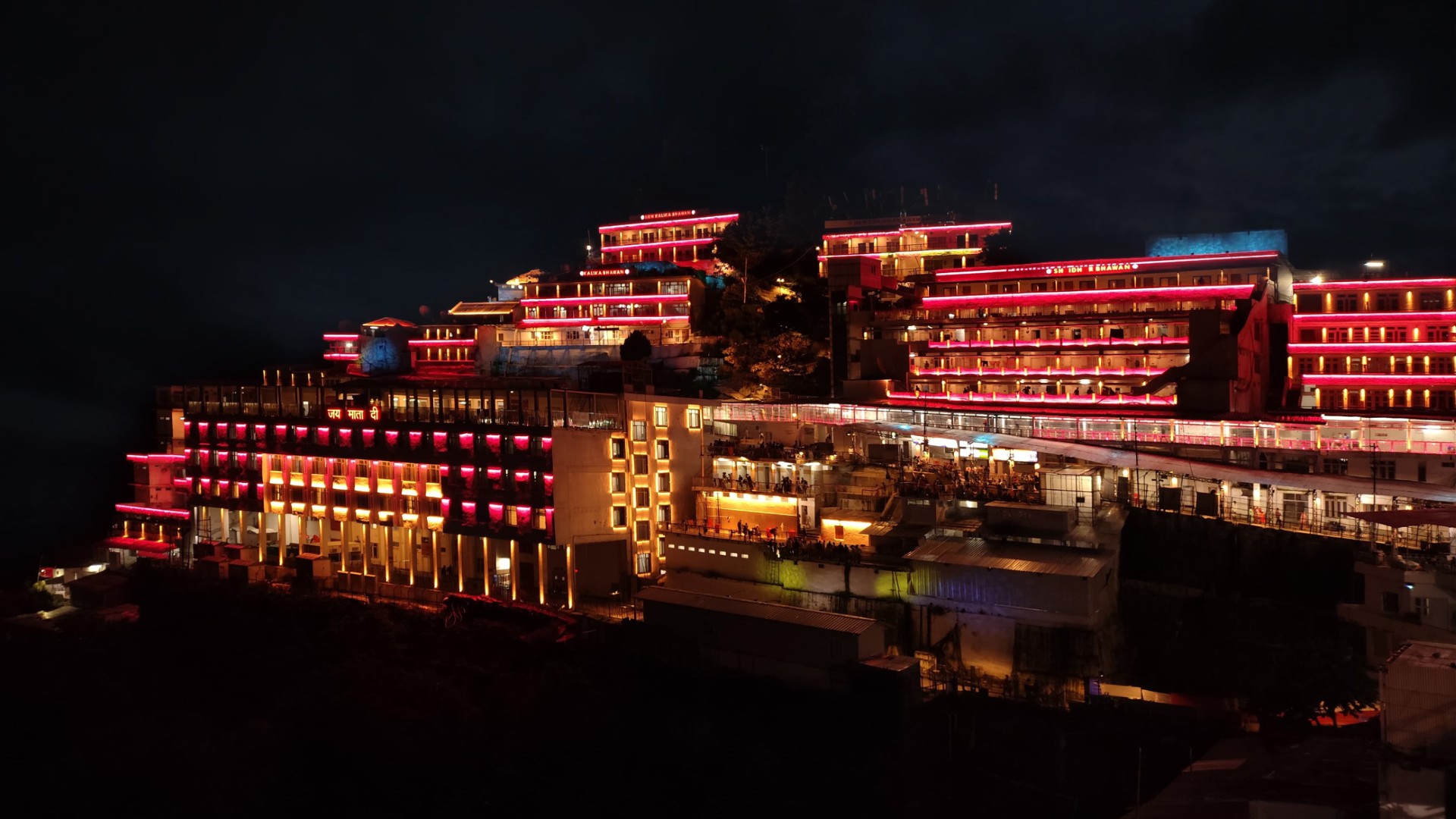 Shri Mata Vaishno Devi Shrine illuminated at night with architectural facade lighting highlighting buildings and pathways in India