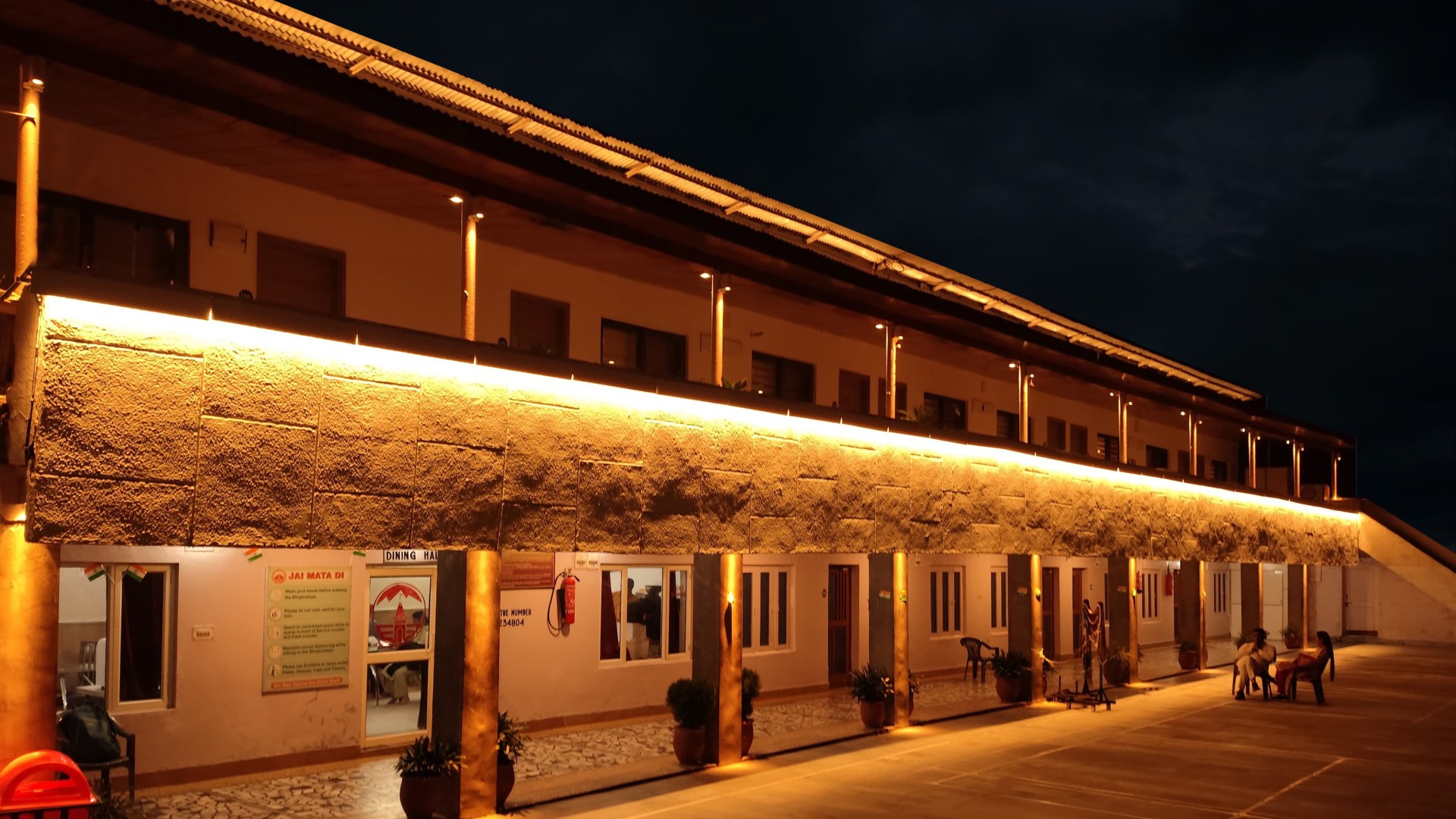 Exterior corridor lighting at Shri Mata Vaishno Devi Shrine with warm facade illumination and clear pedestrian pathways at night