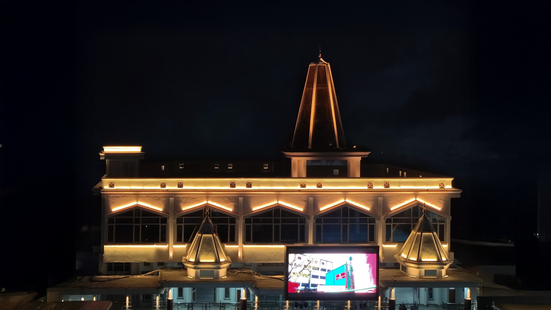 Shri Mata Vaishno Devi Shrine main building illuminated at night with architectural facade lighting highlighting rooflines and structure