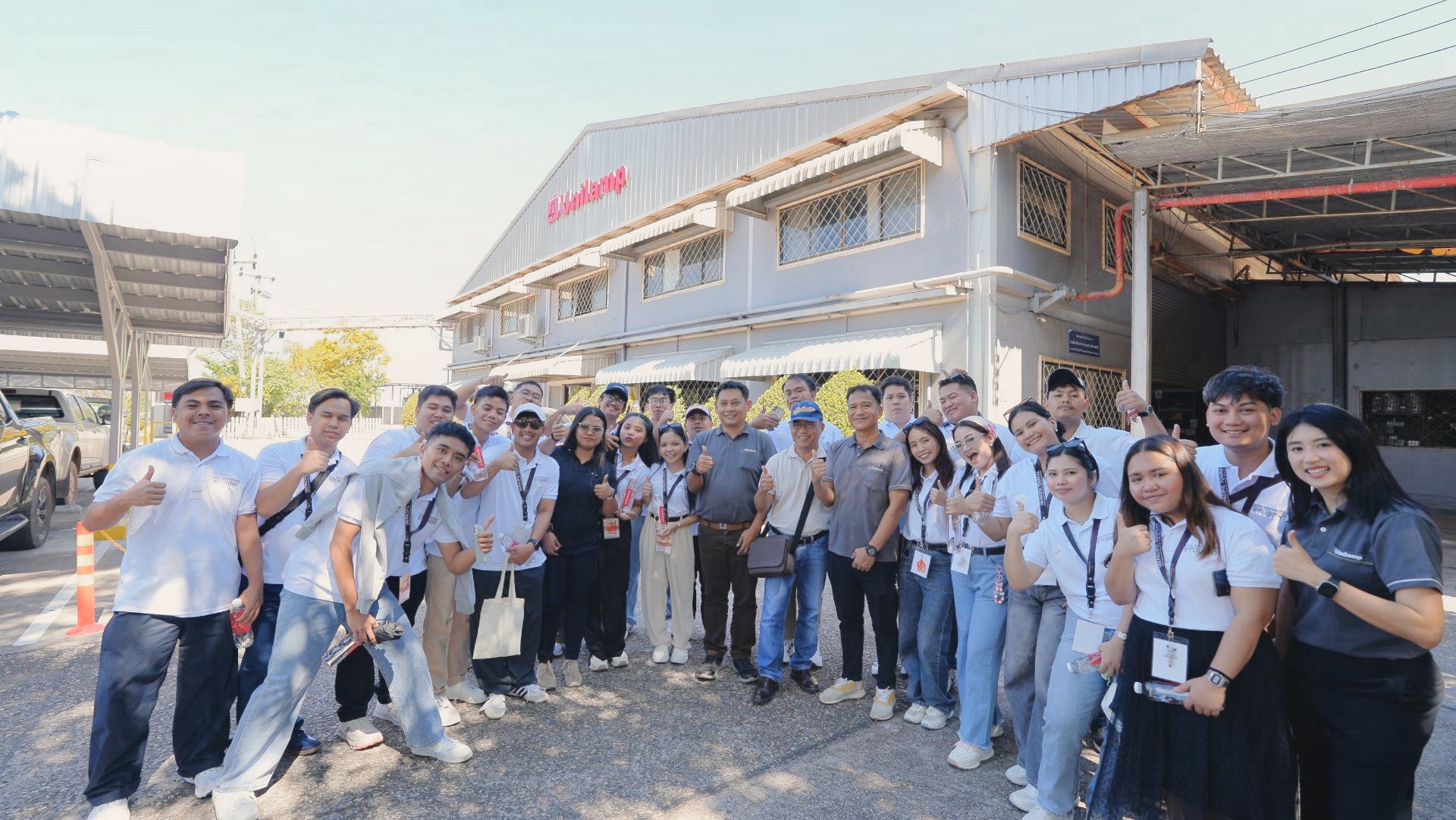 University of Mindanao engineering students taking a group photo during their factory visit at Unilamp in Thailand.