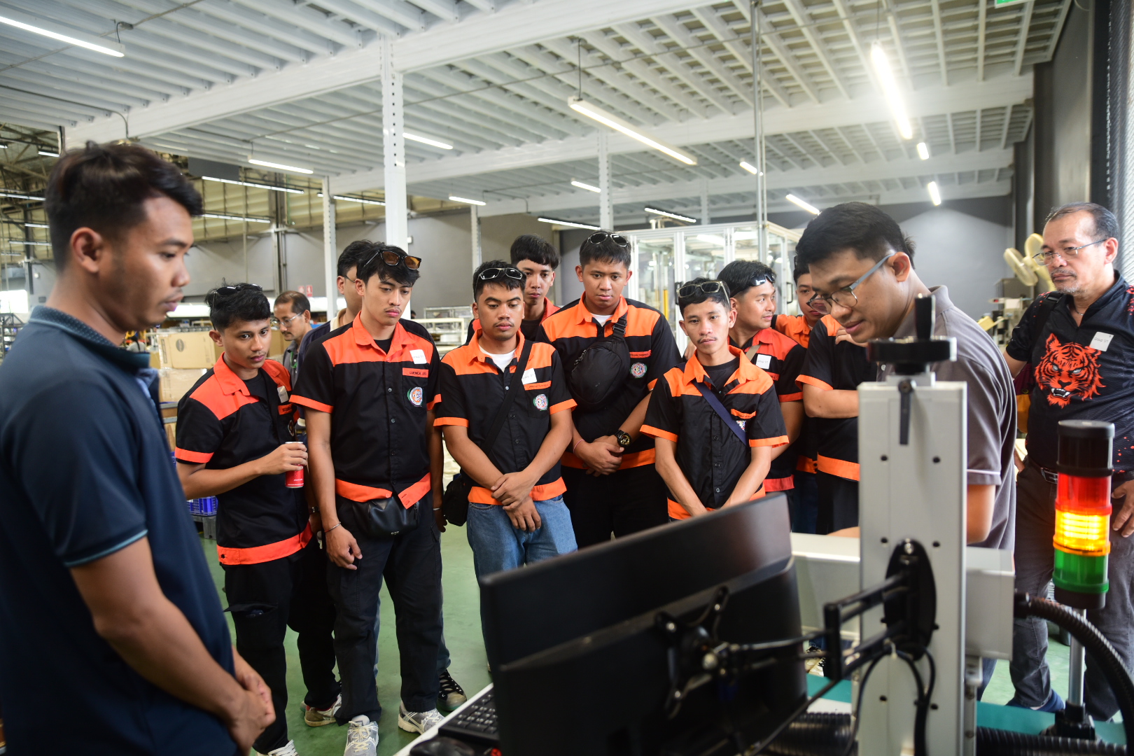 Engineering students learning about automated equipment at Unilamp Thailand