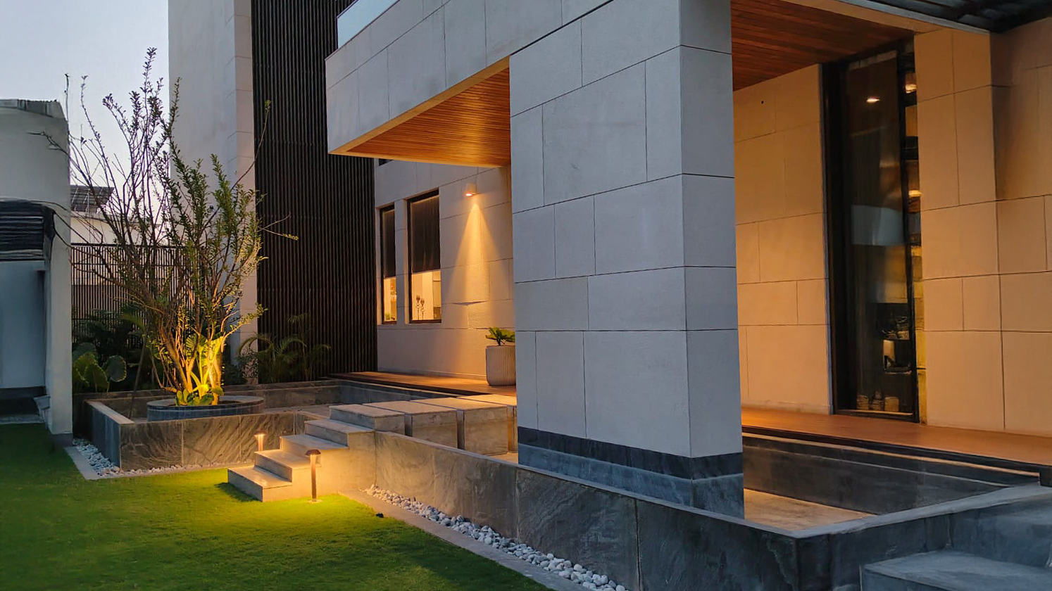 Modern residence in India illuminated by Unilamp CAP bollard lights along garden steps and pathways.