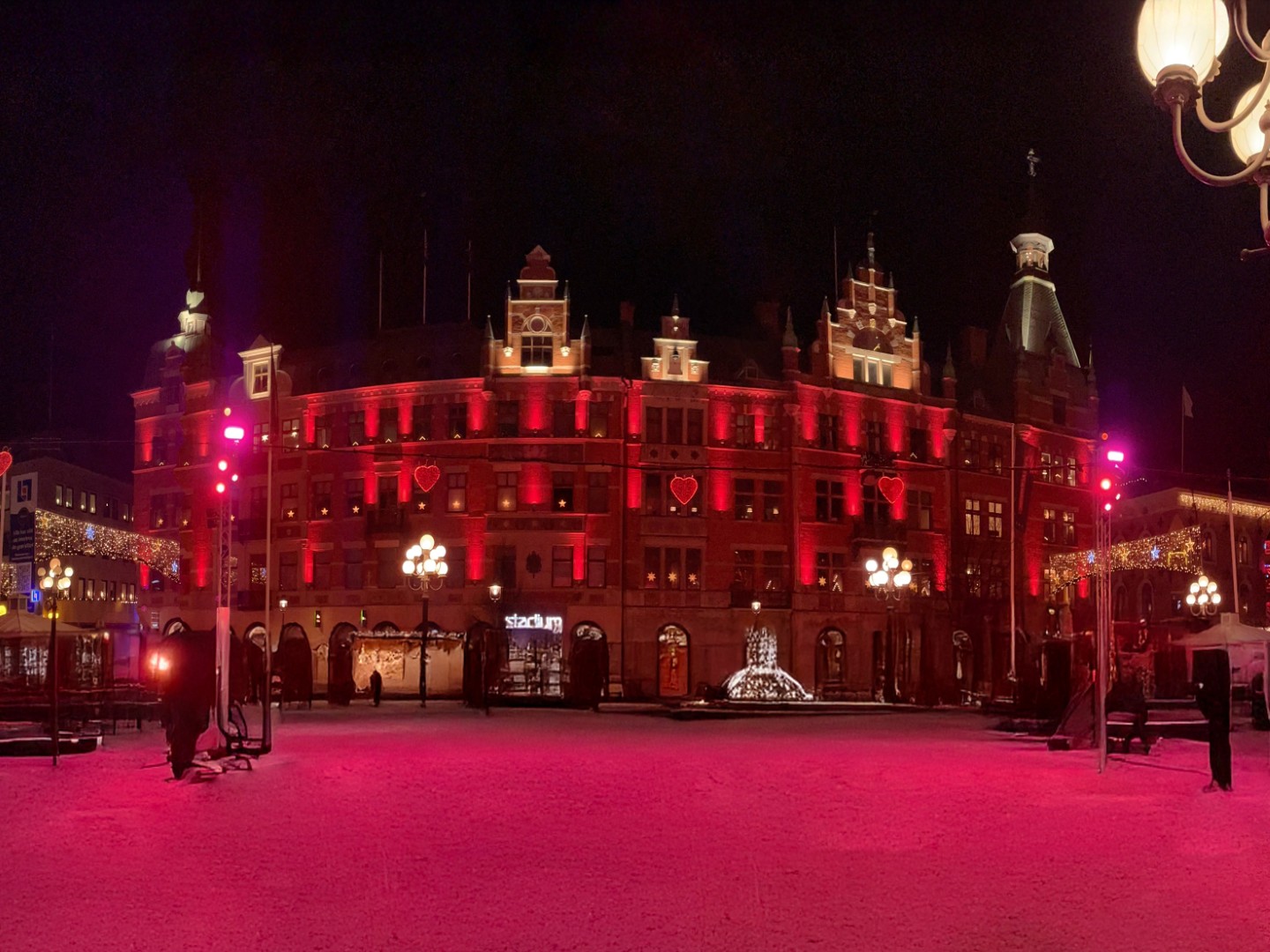 Stora Torget Main Square in Sundsvall illuminated at night with red architectural façade lighting and public square ambience.
